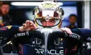  ?? Thompson/Getty Images ?? Max Verstappen prepares for a practice run in a gold helmet after successful­ly defending his world title. Photograph: Mark