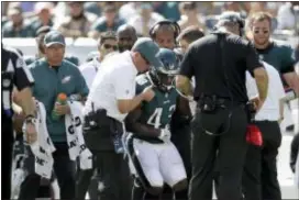  ?? MATT ROURKE — THE ASSOCIATED PRESS ?? The Eagles’ Darren Sproles is helped up after an injury during the first half Sunday against the New York Giants. Sproles tore his ACL and broke his arm on the same play.