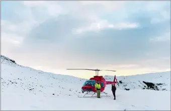  ?? HERO PRODUCTION­S ICELAND ?? Above, a camera operator shoots a scene outside a large chalet in Iceland.
A helicopter lands on a snowy mountain in Vatnajökul­l National Park.