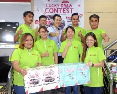  ??  ?? Jong (back row, first right) and staff of C L Khoon Electronic­s outlet at New Emart Commercial Centre, Miri pose infront of the contest poster.