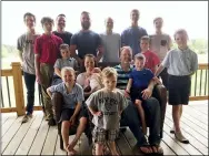  ?? MIKE HOUSEHOLDE­R — THE ASSOCIATED PRESS FILE ?? The Schwandt family poses for a photo at their farm in Lakeview, Mich., in 2018. Standing from left are Tommy, Calvin, Drew, Tyler, Zach, Brandon, Gabe, Vinny and Wesley. Seated, starting at upper left are Charlie, Luke, mother Kateri holding Finley, father Jay with Tucker and Francisco in the foreground. The 14-boy family has welcomed their first daughter nearly three decades after the birth of their first child. Kateri Schwandt gave birth to Maggie Jayne Schwandt Thursday, Nov. 5, at a hospital in Grand Rapids, Mich.