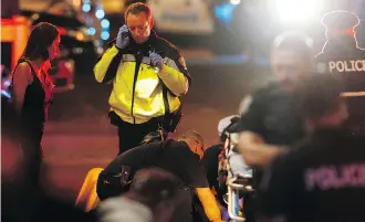  ?? IAN KUCERAK ?? Paramedics perform first aid on a person hit by a U-Haul truck on Jasper Avenue on the night of Sept. 30, 2017.