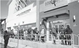  ?? JOHN LOCHER/AP ?? People wait for help with jobless benefits in March at a career center in Las Vegas.