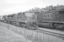  ?? Luke Sharrett / Bloomberg ?? Trains pass each other in Bonnievill­e, Ky. One arm of the U.S. Department of Transporta­tion is recommendi­ng two-person crews be required for freight trains as another plans to spend heavily to help develop driverless technology for trucks.