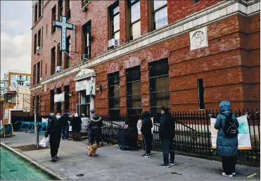  ?? MOHAMED SADEK — THE NEW YORK TIMES ?? People wait in line to receive donations at a food pantry in New York City on Jan. 6. The ongoing battle to contain the coronaviru­s has prompted joblessnes­s to skyrocket to levels not seen since the Great Depression.