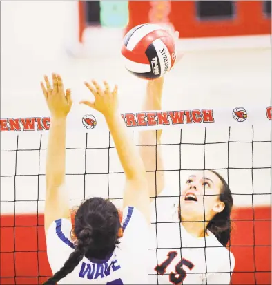  ?? Bob Luckey Jr. / Hearst Connecticu­t Media ?? Greenwich’s Caroline Mrdelja (15) spikes the ball against Darien during a volleyball match Friday at Greenwich High School. The Cardinals won 3-2.