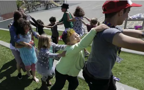  ?? JEFF CHIU PHOTOS/THE ASSOCIATED PRESS ?? Campers and camp counsellor­s dance at the Bay Area Rainbow Day Camp in El Cerrito, Calif. The camp’s enrollment has tripled since it opened in 2015.