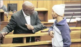 ??  ?? IN COURT: Shaun Rooi talks to his legal representa­tive, Tau Mogwera, during an adjournmen­t in the Northern Cape High Court yesterday.
Picture: Soraya Crowie