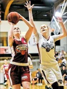  ?? Lake Fong/Post-Gazette ?? Mt. Lebanon’s McKenzie Bushee, left, goes up for a shot as defender Sam Breen closes in one of the four games that made up the Roundball Classic Saturday at Geneva College in Beaver Falls.