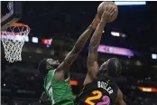  ?? MARTA LAVANDIER — THE ASSOCIATED PRESS ?? Boston Celtics guard Jaylen Brown (7) blocks a shot to the basket by Miami Heat forward Jimmy Butler (22) during the first half Thursday in Miami.