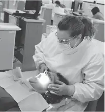  ?? PHOTOS: DAWN VILLELLA/THE ASSOCIATED PRESS/FILES ?? Dental therapists perform procedures that go beyond dental hygiene, such as fillings.