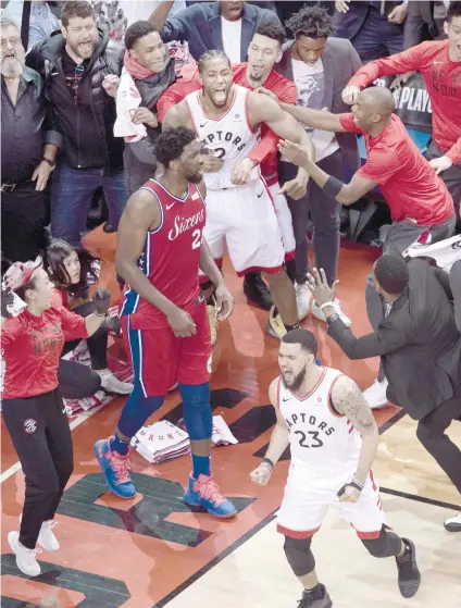  ?? AP FOTO ?? HISTORIC SHOT. Toronto Raptors forward Kawhi Leonard (wearing white No. 2 jersey) reacts with teammates after making the buzzer-beating shot in Game 7 against the Philadelph­ia 76ers.