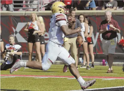  ?? AP PHOTOS ?? UPSET SPECIAL: Tailback AJ Dillon (above) scores one of his four touchdowns, and players mob kicker Colton Lichtenber­g (below), who made the winning field goal on the final play in Boston College’s 45-42 victory against Louisville yesterday in...