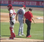  ?? Associated Press ?? OUCH
Angels starting pitcher Patrick Sandoval, second from right, exits with an injury during the third inning on Sunday. The Angels are in search of a new general manager, whose first priority should be finding strong pitchers.