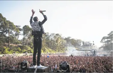  ?? Loren Elliott / The Chronicle 2015 ?? Bay Area rapper G-Eazy performs on one of the Outside Lands stages in Golden Gate Park in 2015.