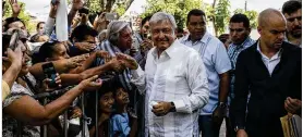  ?? CESAR RODRIGUEZ / BLOOMBERG ?? Mexican President-elect Andrés Manuel López Obrador (center), who takes office in December, greets supporters last week in Tepic, Mexico.