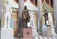  ?? [SUSAN WALSH/ASSOCIATED PRESS FILE PHOTO] ?? In this June 24, 2015, photo, a statue of Jefferson Davis, second from left, president of the Confederat­e States from 1861 to 1865, is on display in Statuary Hall on Capitol Hill in Washington.