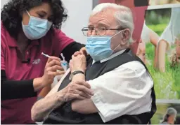  ?? PETER DEJONG/AP ?? Okko Molenkamp, 94, is injected with a COVID-19 vaccine in Apeldoorn, Netherland­s, on Tuesday.