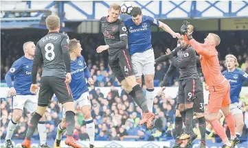  ??  ?? Arsenal’s German defender Per Mertesacke­r (fourth left) and Everton’s English defender Michael Keane (fourth right) head the ball during the English Premier League football match between Everton and Arsenal at Goodison Park in Liverpool, north west...