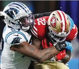  ?? RUSTY JONES — THE ASSOCIATED PRESS ?? San Francisco 49ers running back Jeff Wilson Jr. is tackled by Carolina Panthers linebacker Damien Wilson during the second half last Sunday, Oct. 9, in Charlotte, N.C.