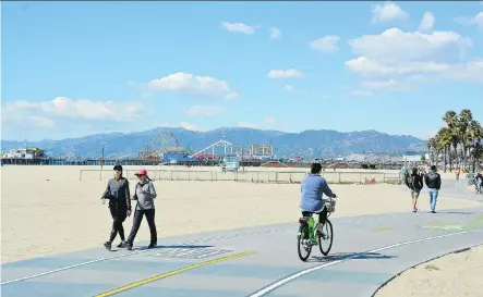  ?? PHOTOS: COURTESY, GREG OLSEN ?? Ocean Front Walk is a popular place to walk, run, cycle or Segway on a sunny afternoon, thanks to wonderful views and several attraction­s. It stretches 6.5 km from the north end of Venice Beach to well past the famous Santa Monica Pier, pictured in the...