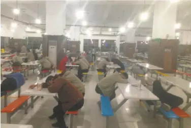  ?? China Labor Watch ?? Workers sleep in the cafeteria of Catcher, a Chinese supplier to Apple, during the rest time following a meal. China Labor Watch investigat­ed Catcher from October through January.