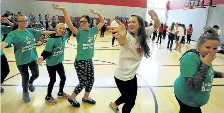  ?? CLIFFORD SKARSTEDT/EXAMINER ?? Two-time Olympian and 2016 Olympic Bronze Medallist, swimming athlete Brittany MacLean dances with participan­ts during the Jumpstart Women and Girls in Sport Initiative event on Friday at the YMCA on Aylmer Street. More than 300 girls ages 8 to 14...