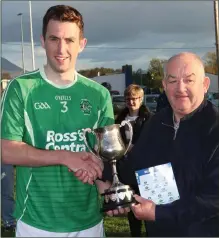  ?? Ballyduff captain Paul O’Carroll acccepts the CountyJuni­or Club Championsh­ip cup from Diarmuid O Sé after the 2019 final ??