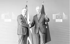  ??  ?? EU chief Brexit negotiator Barnier (right) and Britain’s Secretary of State for exiting the EU, Brexit Minister, Raab pose after a joint press conference after their meeting at the European Commission in Brussels. Barnier and his British counterpar­t Raab said after talks in Brussels that key difference­s remained and it was important to “intensify” the pace of negotiatio­ns. — AFP photo