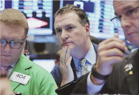  ?? AP PHOTO ?? KEEPING THINGS IN PERSPECTIV­E: Trader Jonathan Corpina, center, looks pensive on the floor of the New York Stock Exchange last week.