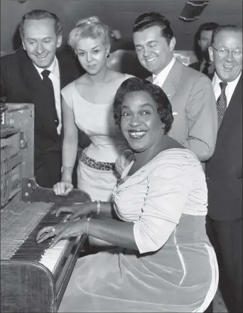  ?? PICTURE: PA WIRE ?? LET’S HAVE A PARTY: Winifred Atwell at her upright piano, watched over by admirers including Hughie Green.