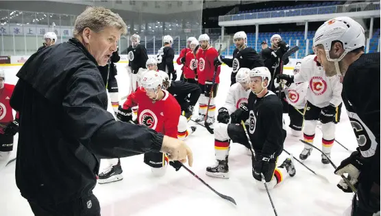  ?? THE ASSOCIATED PRESS ?? Flames head coach Bill Peters drives home a point during a practice in Beijing, China. The new boss says the Flames appear to be“a real coachable group.”