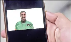  ?? — AFP photo ?? A Pakistani man watches the latest video statement released by Pakistan’s military authoritie­s of Abhinandan on his smartphone in Islamabad.