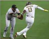  ?? DERRICK TUSKAN — THE ASSOCIATED PRESS ?? Giants relief pitcher Reyes Moronta tags out the Padres’ Manny Machado on Tuesday in San Diego.