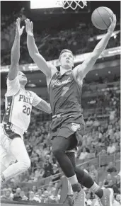  ?? PATRICK FARRELL/MIAMI HERALD ?? Goran Dragic, who led the Heat with 22 points Monday night, drives to the basket past the 76ers’ Markelle Fultz at American Airlines Arena in Miami.