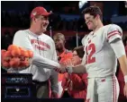  ?? GETTY IMAGES ?? Quarterbac­k Alex Hornibrook and coach Paul Chryst enjoy the Badgers’ victory over Miami in the Orange Bowl last season.