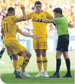  ??  ?? A tale of two penalties. Uruguayan Andres Cunha awards one to France after consulting VAR, before giving another to Australia – after just a little advice from midfielder Tom Rogic