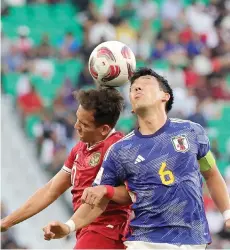  ?? — AFP file photo ?? Indonesia’s Egy Maulana Vikri and Japan’s Wataru Endo vie for a header during the Group D match at al-Thumama Stadium in Doha.