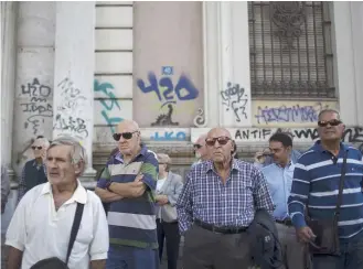  ??  ?? Pensioners take part in a protest rally outside the country’s highest administra­tive court in central Athens, yesterday.