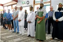  ?? JOHN HAWKINS/ STUFF ?? Two minutes’ silence is observed in the Invercargi­ll Mosque, which was open to members of the public.