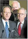 ?? The New York Times/AL DRAGO ?? Senate Majority Leader Mitch McConnell (right) joins Sen. Patrick Toomey (left), R-Pa., and other GOP senators Tuesday in announcing that a provision to end the individual mandate for health care was being added to their tax overhaul plan.