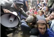  ?? — AFP ?? Israeli police evict settlers in the Netiv Haavot neighbourh­ood of the Elazar settlement, south of Jerusalem on Tuesday.