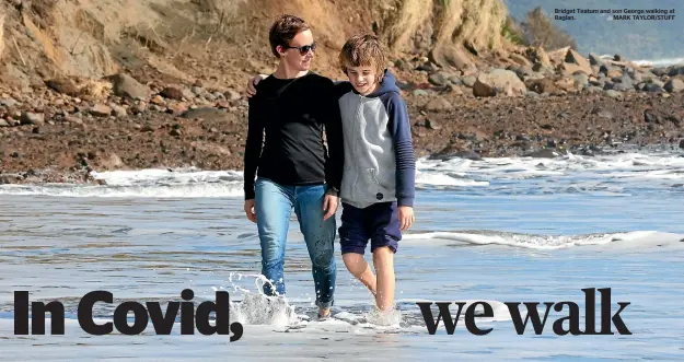  ?? ?? Holly Thorpe goes for a walk with Jet and daughter Bella at Wainui beach, Gisborne.
Bridget Teatum and son George walking at Raglan. MARK TAYLOR/STUFF