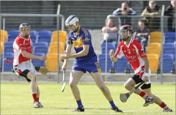  ??  ?? Carnew’s Martin O’Brien looks to clear the danger during the SHC in Aughrim.