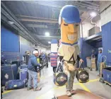  ?? JOURNAL SENTINEL MIKE DE SISTI / MILWAUKEE ?? The Hot Dog helps load the truck Feb. 6 as other newly named Johnsonvil­le Famous Racing Sausages, formerly the Famous Klement's Racing Sausages, were on hand to help the Brewers pack up for spring workouts in Arizona.