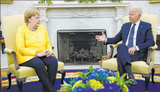  ?? Evan Vucci The Associated Press ?? President Joe Biden meets Thursday with German Chancellor Angela Merkel in the Oval Office.