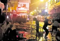  ?? —REUTERS ?? NEW BATTLEGROU­ND Demonstrat­ors protesting against COVID-19 restrictio­ns throw glass bottles at riot police in Guangzhou, Guangdong province, China, in this screen grab taken from a social media video released Nov. 30.