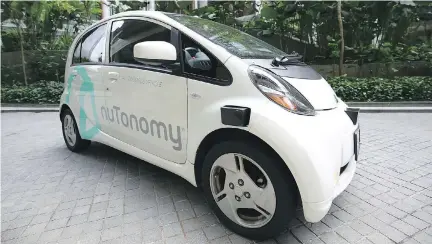  ?? YONG TECK LIM/THE ASSOCIATED PRESS ?? An autonomous vehicle is parked for its test drive in Singapore on Wednesday.