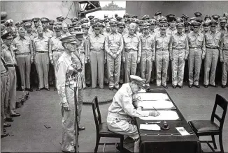  ?? U.S. NAVY ?? Gen. Douglas MacArthur signs the Japanese surrender documents on Sept. 2, 1945, aboard the USS Missouri in Tokyo Bay, marking the end of World War II, and declared: “A great tragedy has ended. A great victory has been won. The skies no longer rain death ... the entire world is quietly at peace.”