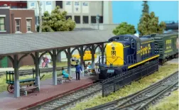  ?? Rich Hall photo ?? A newly painted Alco brings the morning mixed into Denton, Texas, on Ron Stallman’s compact HO scale layout.